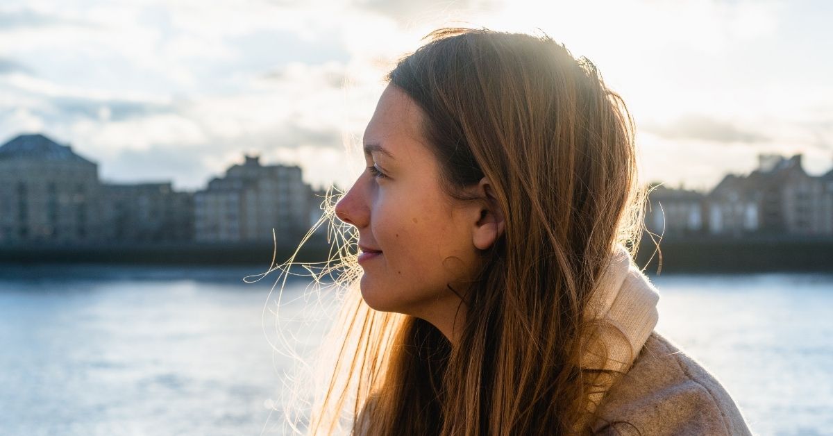 Woman at sunset staring into distance. But God Bible Verses